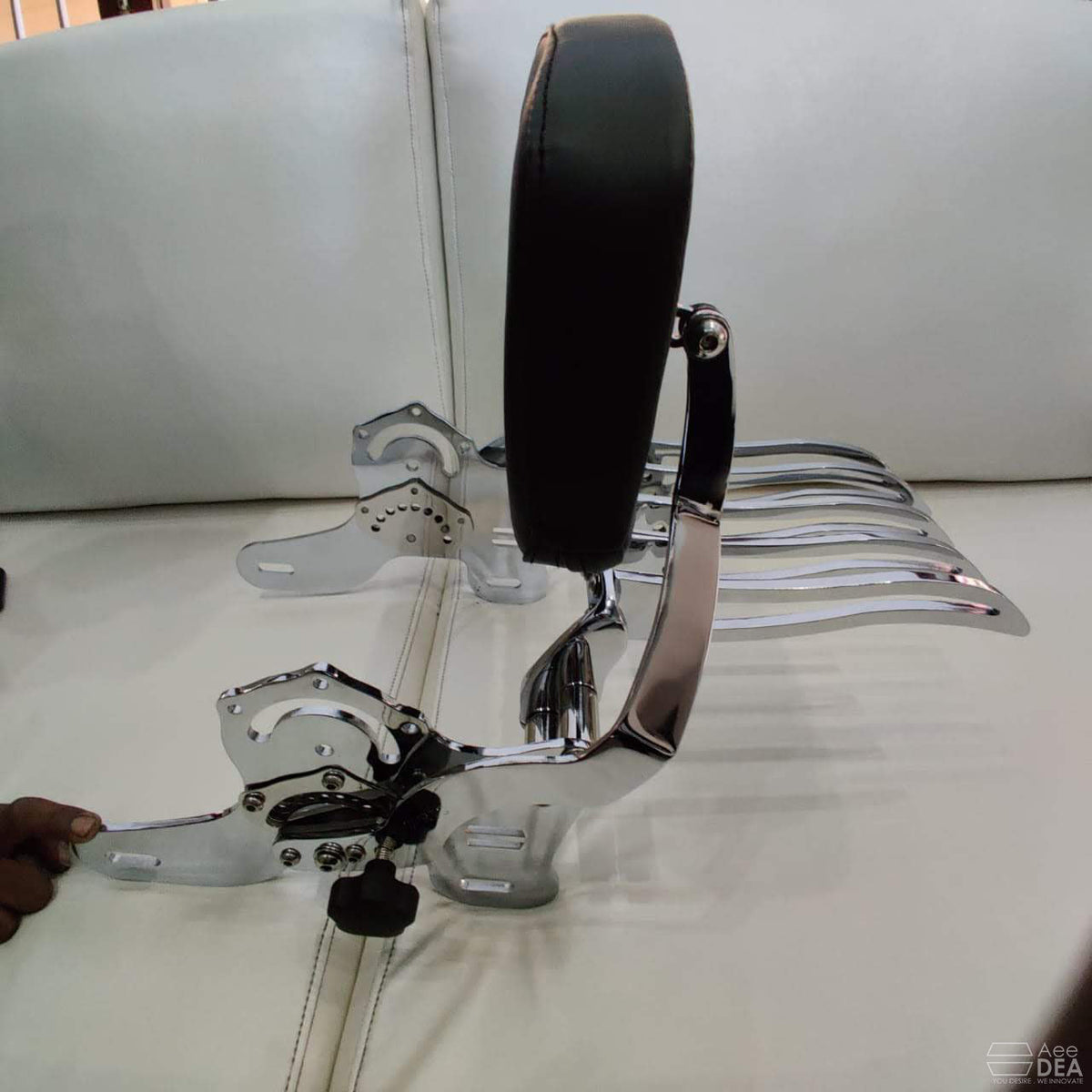 Close-up of motorcycle backrest adjustment mechanism and mounting components