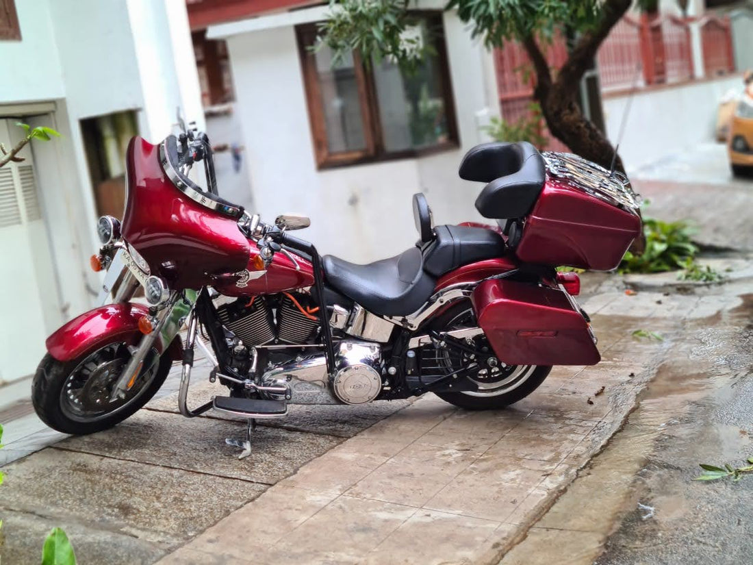 Red touring cruiser fitted with AeeDEA side panniers and a matching rear top box