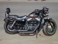 Cruiser motorcycle with adjustable backrest positioned behind the rider