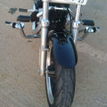 Front view of a motorcycle showing the highway footpeg mounting positions