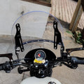 Rider's view through the adjustable motorcycle windshield from behind the handlebar