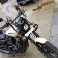 Side view of motorcycle showing the adjustable windshield mounted above the headlight