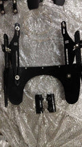 Close-up of the stainless steel restrainers and mounting components on the windshield