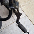 Black foldable AeeDEA highway footpeg mounted on a motorcycle engine guard