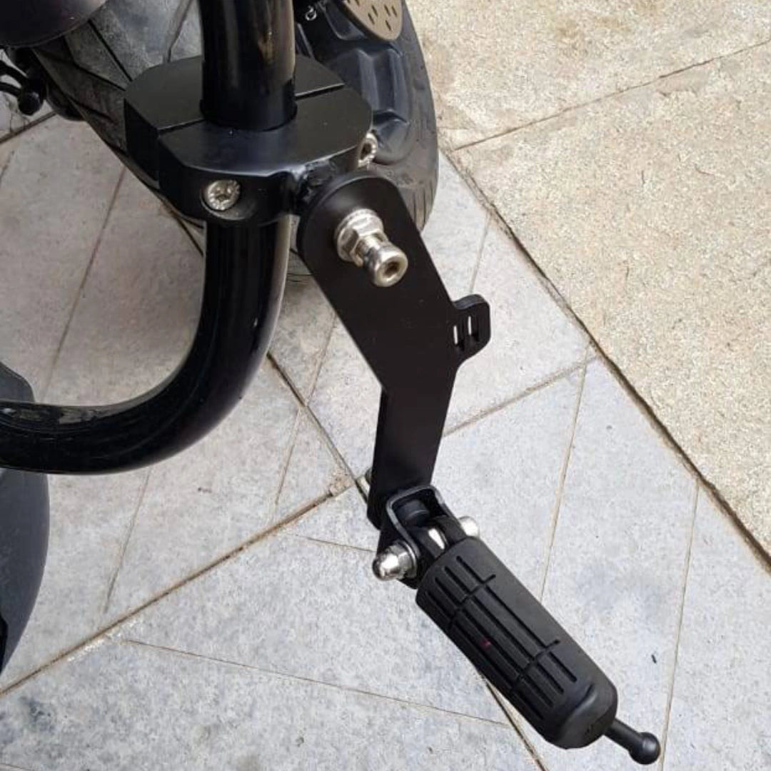 Black foldable AeeDEA highway footpeg mounted on a motorcycle engine guard