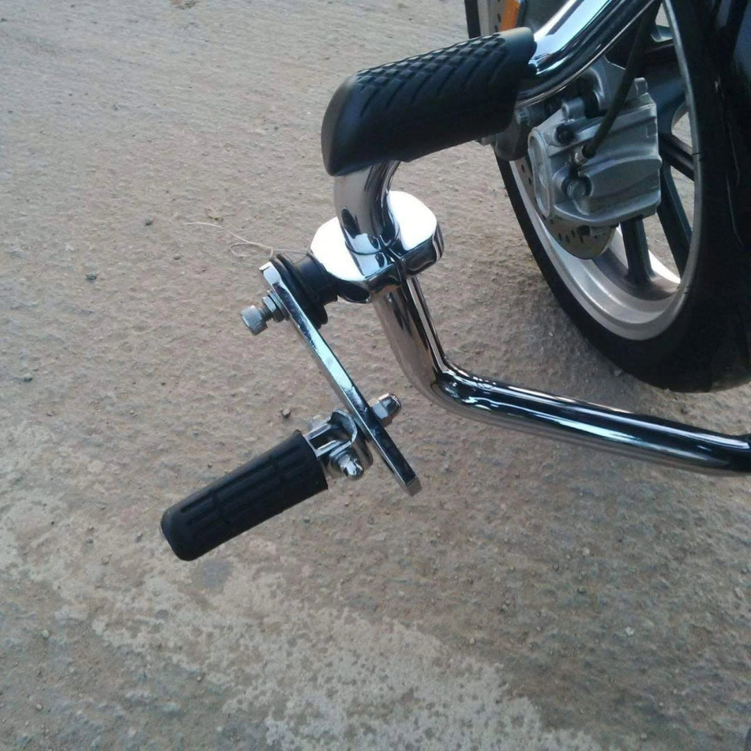 Adjustable black highway footpeg fitted to a motorcycle engine guard