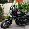 Black motorcycle fitted with a clear adjustable windshield above the headlight