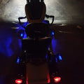Rear view of motorcycle with illuminated footboard area and tail lights