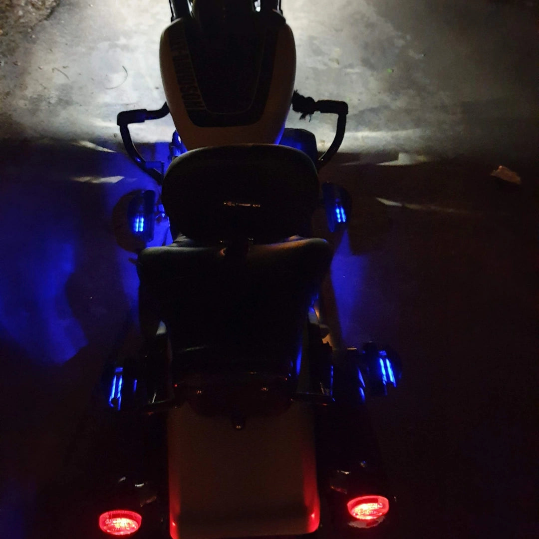 Rear view of motorcycle with illuminated footboard area and tail lights