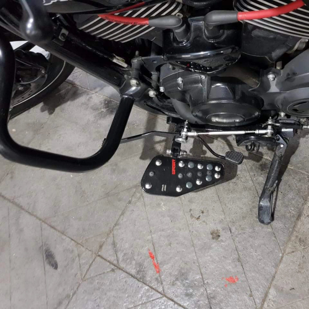 Motorcycle showing the forward control footboard fitted beside the engine