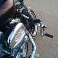 Side view of a motorcycle with adjustable highway footboards mounted near the engine