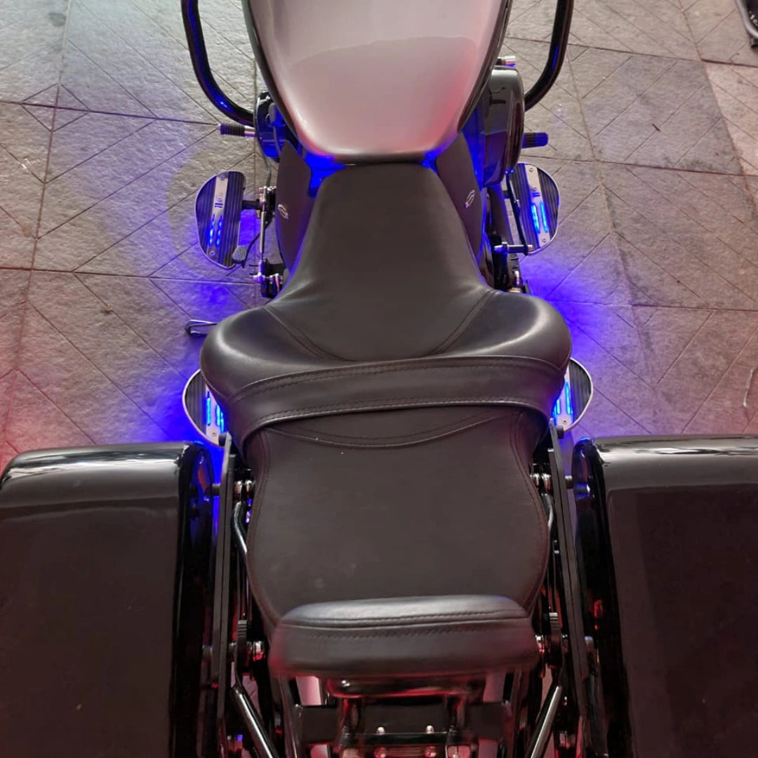 Rear view of motorcycle fitted with AeeDEA forward control footboards and blue accent lighting
