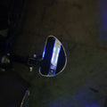 Side detail of an illuminated motorcycle mid-mount footboard