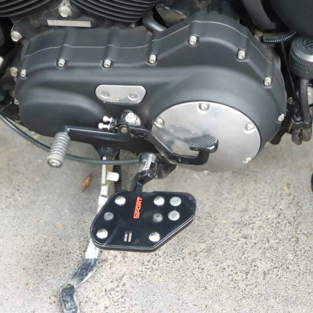Mid-mount rider footboards shown beside the motorcycle engine