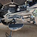Side view of AeeDEA mid-mount rider footboards installed on a motorcycle