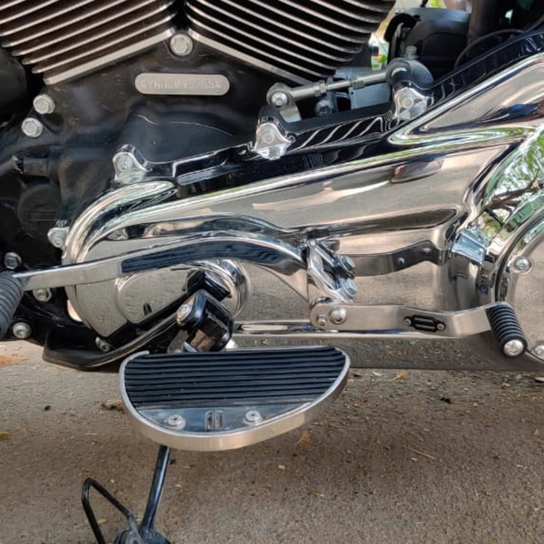 Side view of AeeDEA mid-mount rider footboards installed on a motorcycle