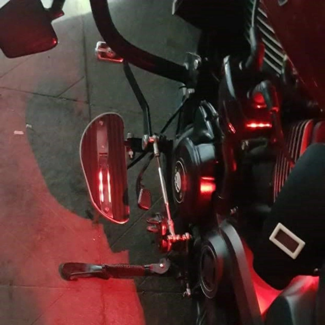 Close-up of an AeeDEA mid-mount rider footboard with red LED illumination