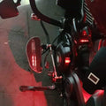 Close-up of an AeeDEA mid-mount rider footboard with red LED illumination
