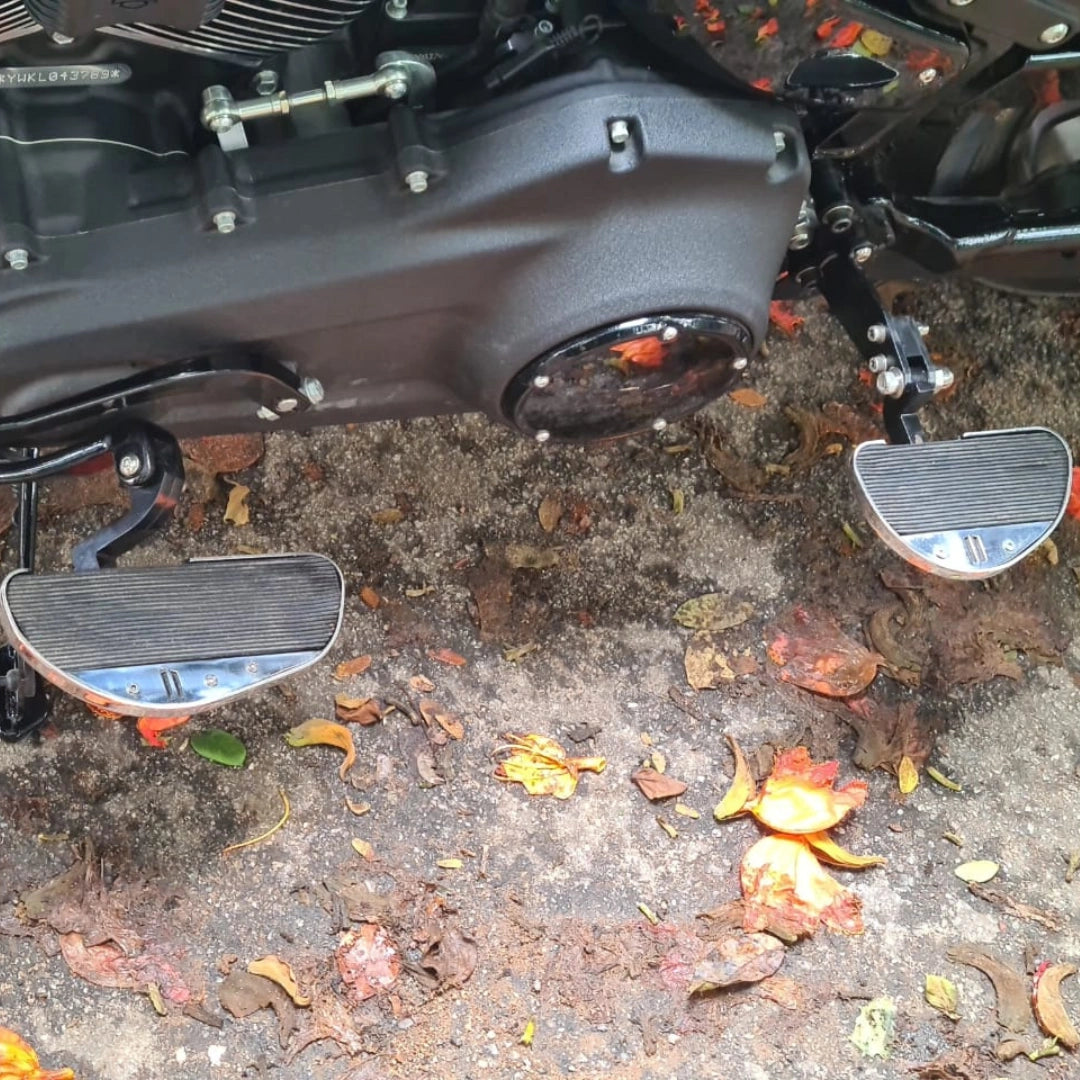 Close-up of AeeDEA motorcycle pillion footboards installed beside the engine