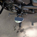 Close-up showing the installed position of a mid-mount motorcycle rider footboard