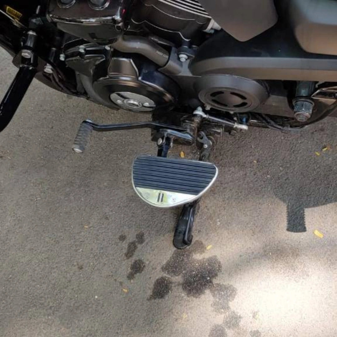 Close-up showing the installed position of a mid-mount motorcycle rider footboard