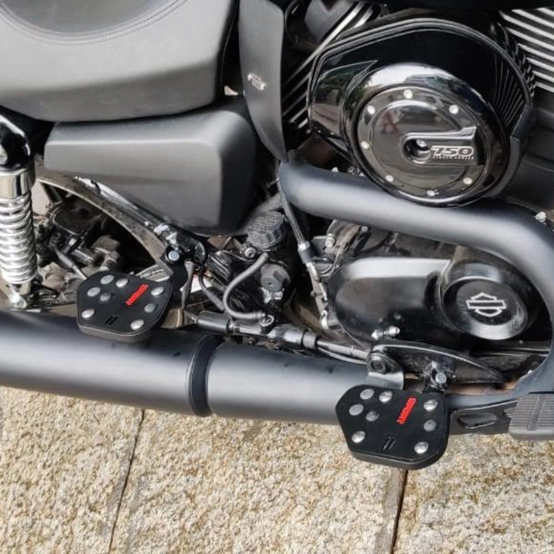 Motorcycle engine and mid-mount rider footboard viewed from the side