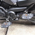 Close-up of Sports style rider footboard installed beside the motorcycle engine