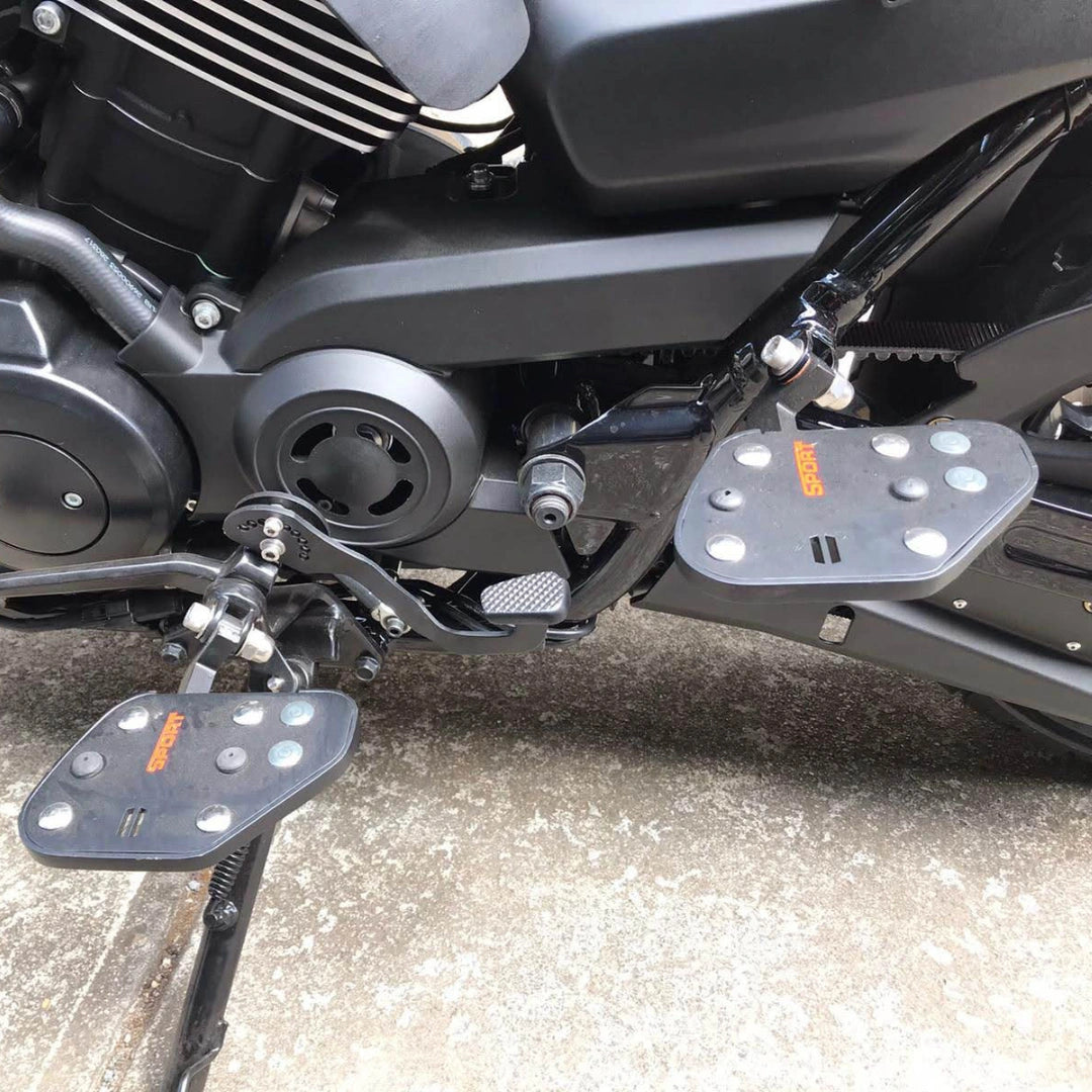 Close-up of Sports style rider footboard installed beside the motorcycle engine