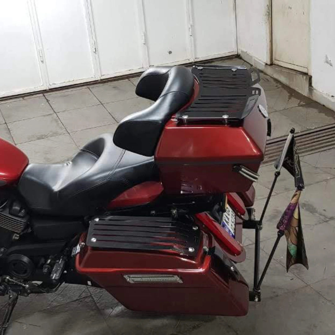 Rear side view of motorcycle fitted with a red touring pannier and luggage mounting system