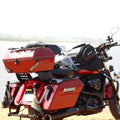 Rear three-quarter view of motorcycle fitted with red touring panniers