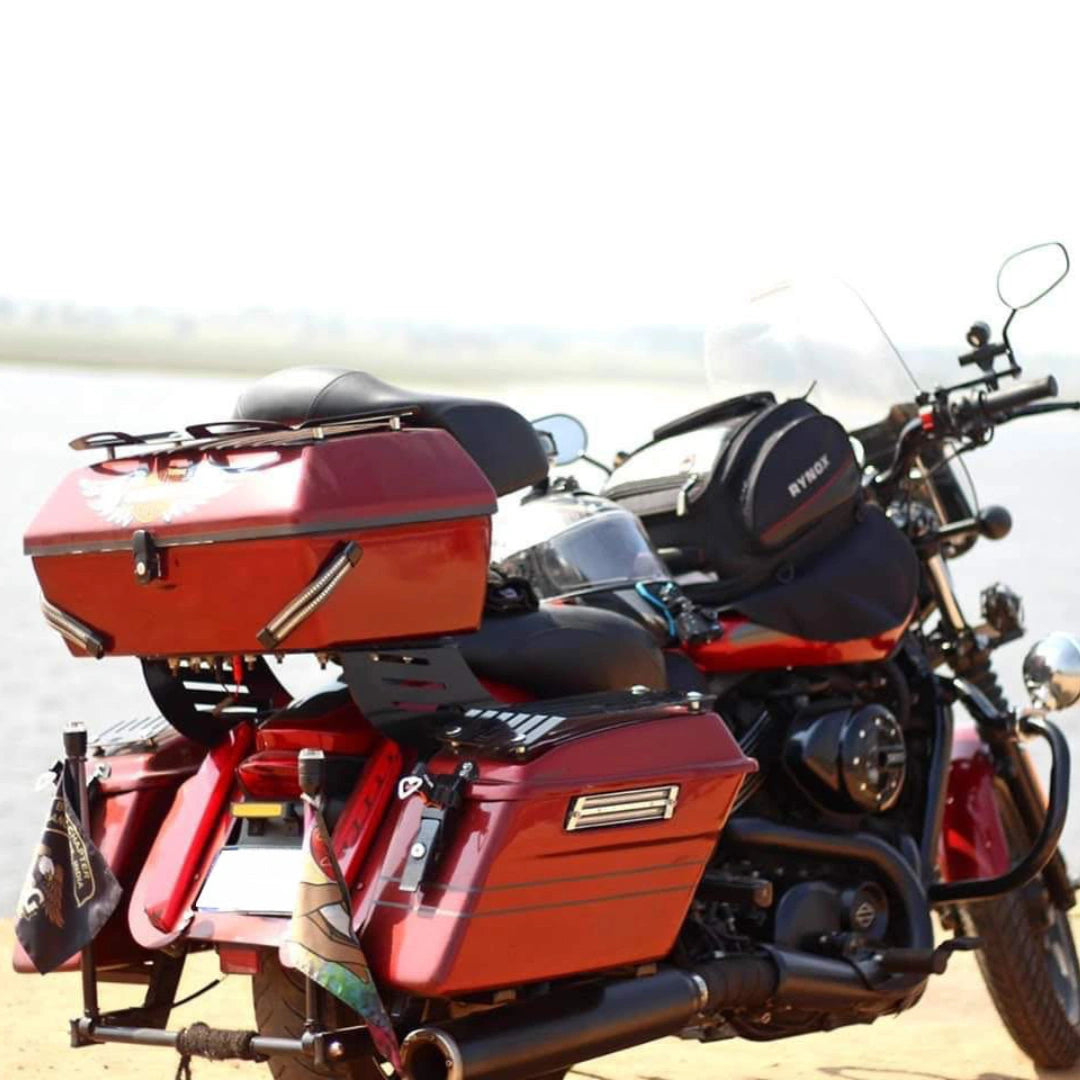 Rear three-quarter view of motorcycle fitted with red touring panniers