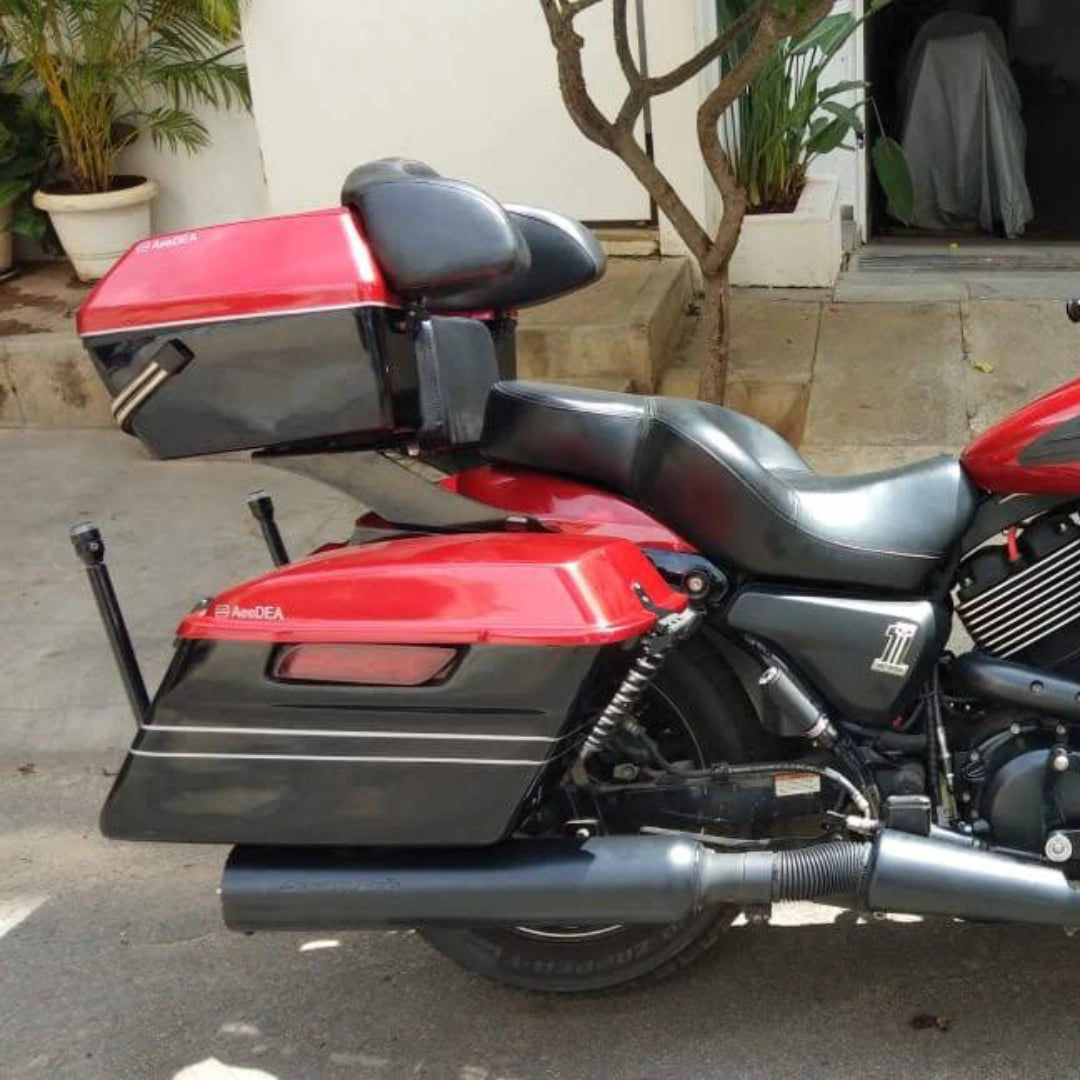 Red motorcycle fitted with AeeDEA touring side panniers and black mounting carriage