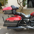 Red motorcycle fitted with AeeDEA touring side panniers and black mounting carriage