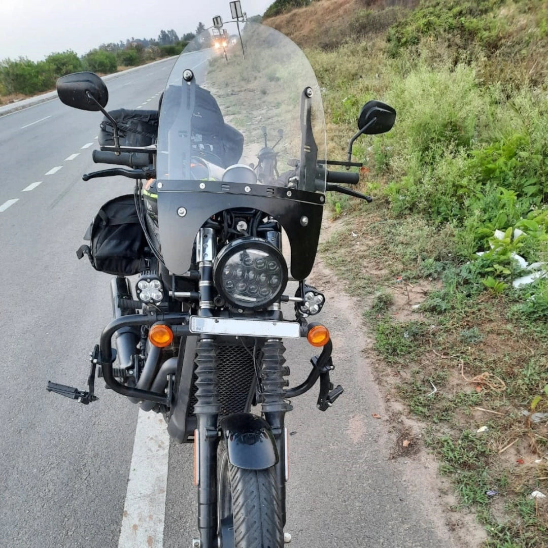 Front view of a motorcycle showing the clear windshield and mounting arrangement