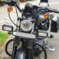 Close-up of metal auxiliary light mounting hardware on a motorcycle