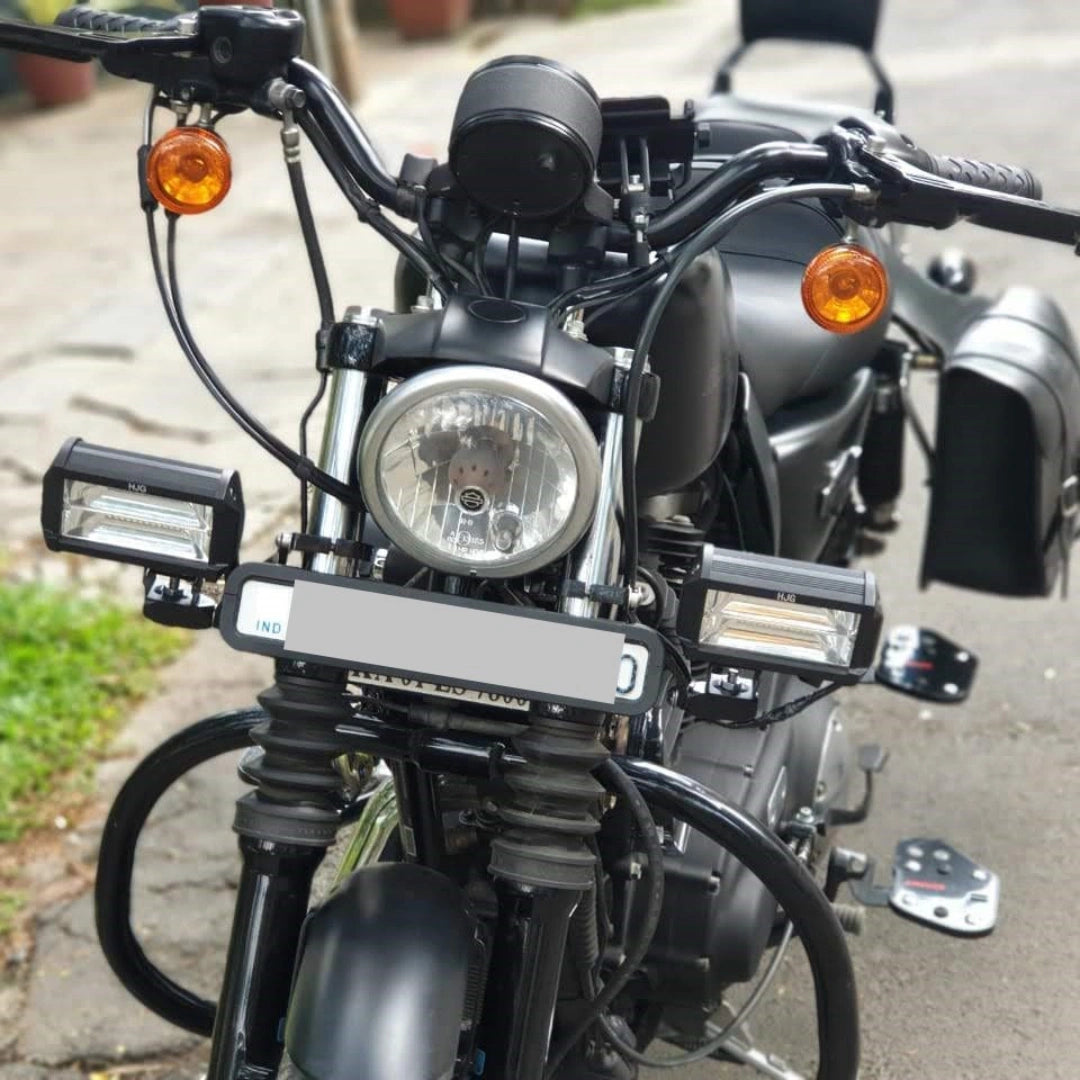 Close-up of metal auxiliary light mounting hardware on a motorcycle
