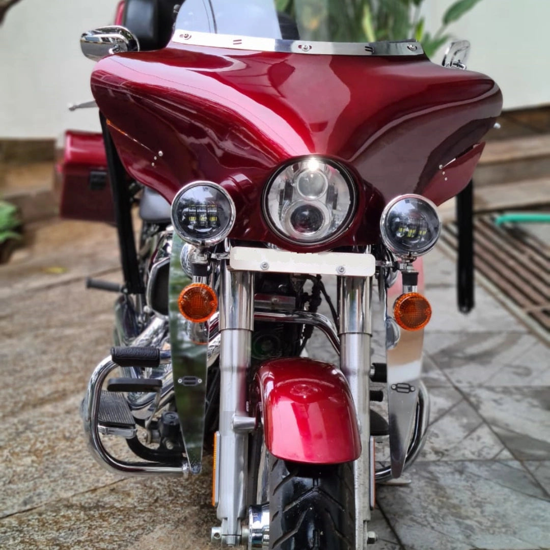 Red motorcycle fitted with front auxiliary lights