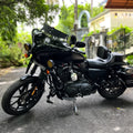 Black motorcycle fitted with a Batwing fairing and windshield