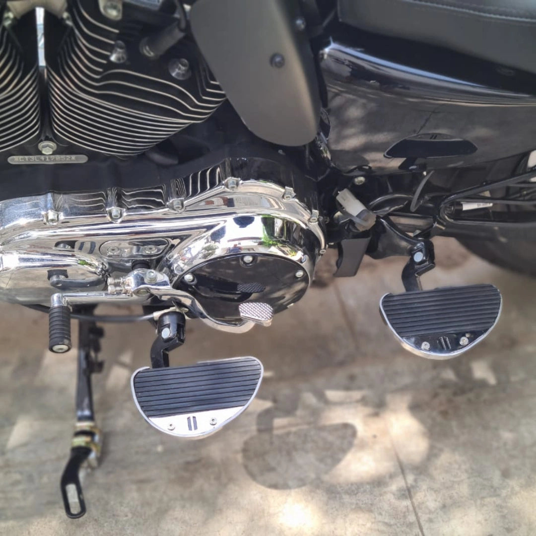 Close-up of chrome rider footboards fitted to a motorcycle