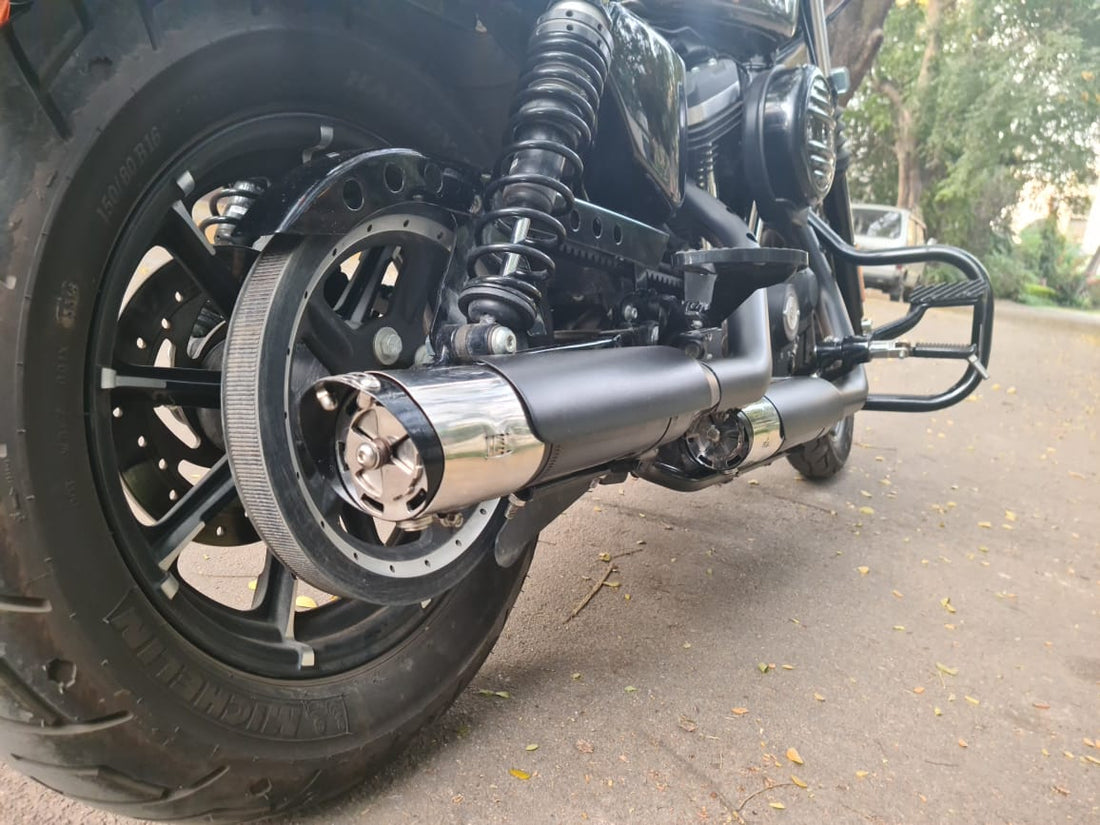 Close-up of AeeDEA black variable sound exhaust with metallic end caps installed on a motorcycle
