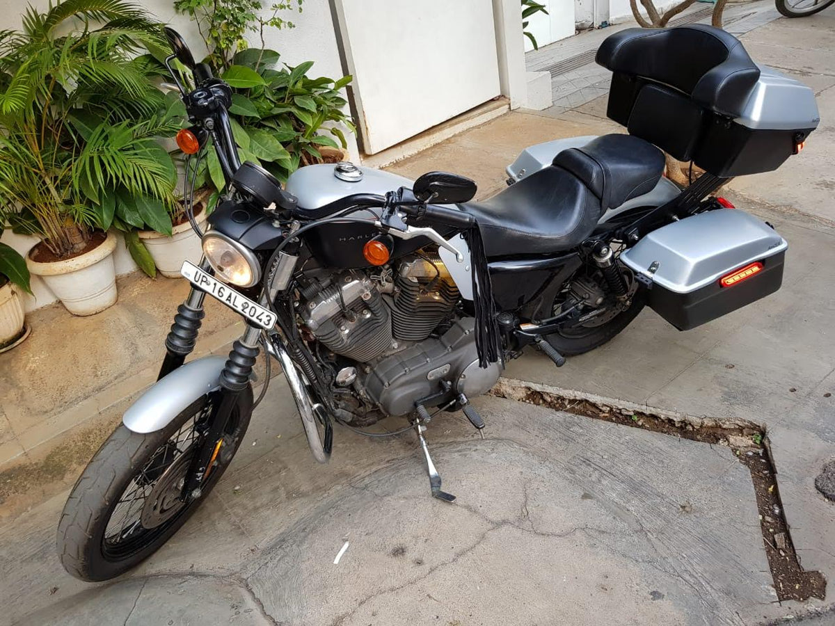 Front three-quarter view of a motorcycle fitted with engine heat deflectors
