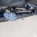 Side view of foldable motorcycle rider footboard mounted below the engine