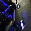Close-up of blue illuminated motorcycle footboard