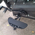 Close-up of AeeDEA forward control footboard installed beside the motorcycle