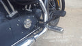 Close-up of the forward control brake pedal and mounting linkage on a motorcycle