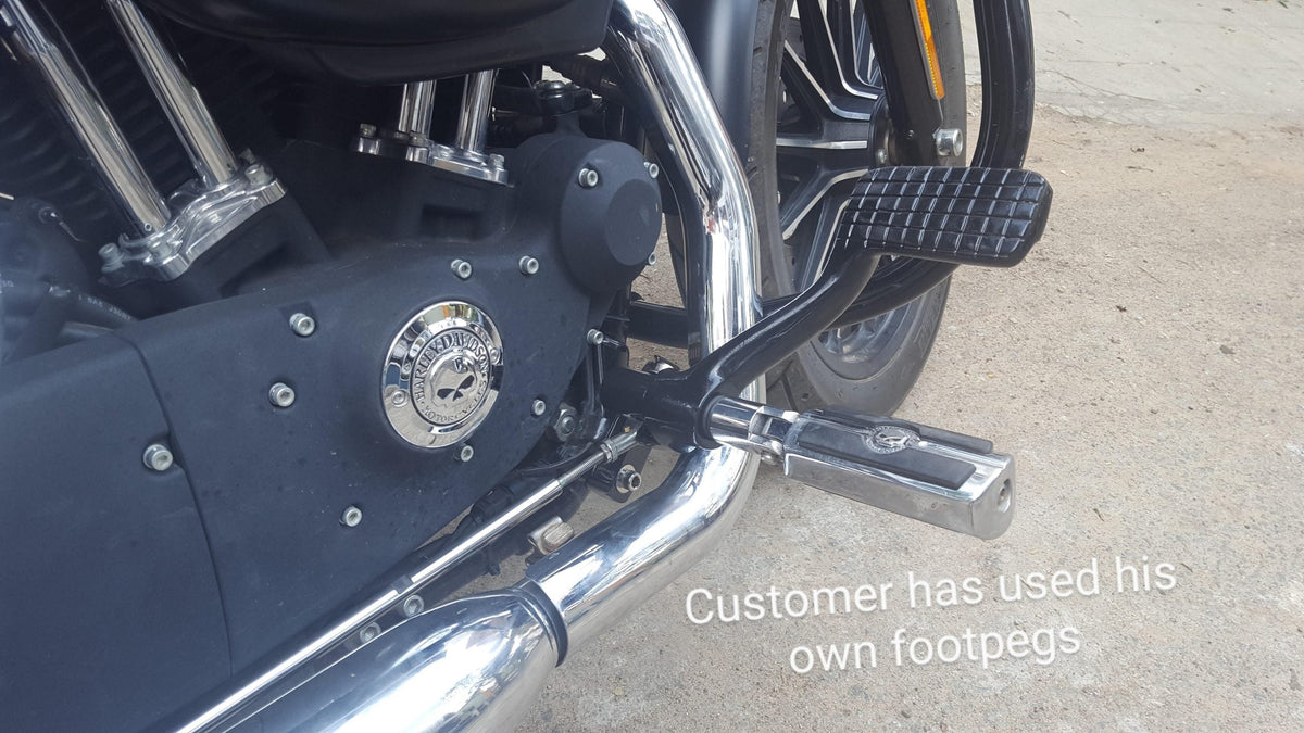 Close-up of the forward control brake pedal and mounting linkage on a motorcycle