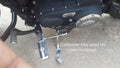 Close-up of the brake and gear shafts connected to the motorcycle forward controls
