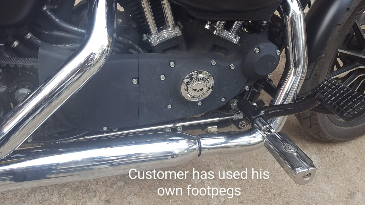 Forward foot controls installed on a motorcycle using the rider's existing footpegs