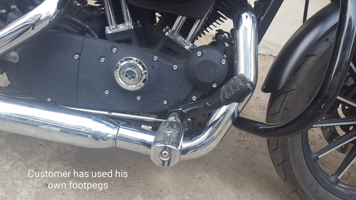 Motorcycle forward foot controls showing the gear linkage and extended mounting position