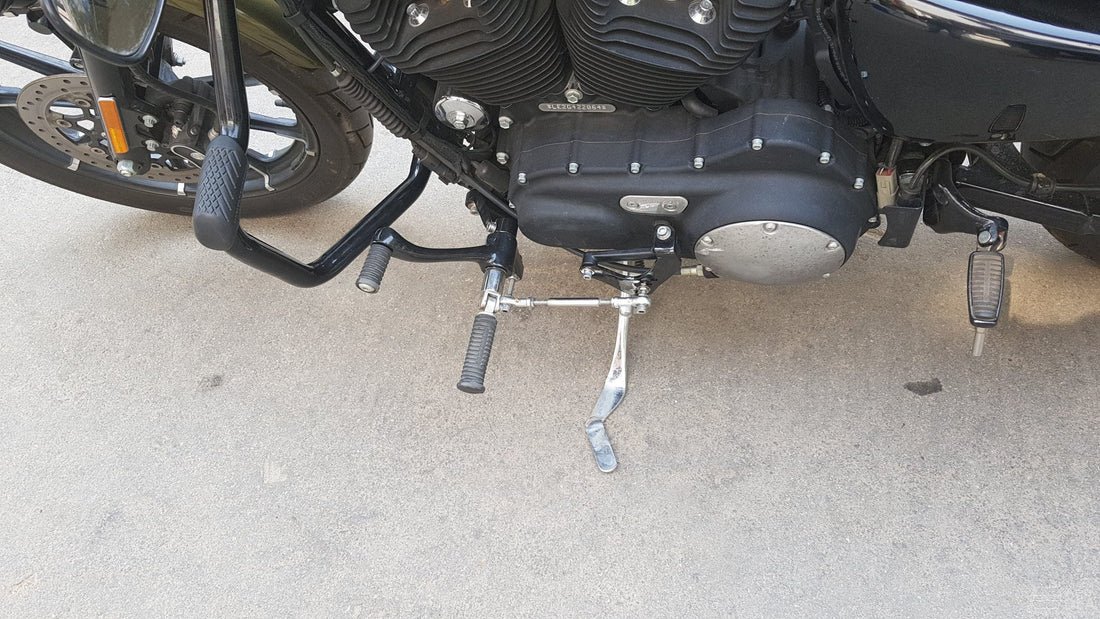 Motorcycle forward foot controls installed beside the engine with extended brake and gear linkages